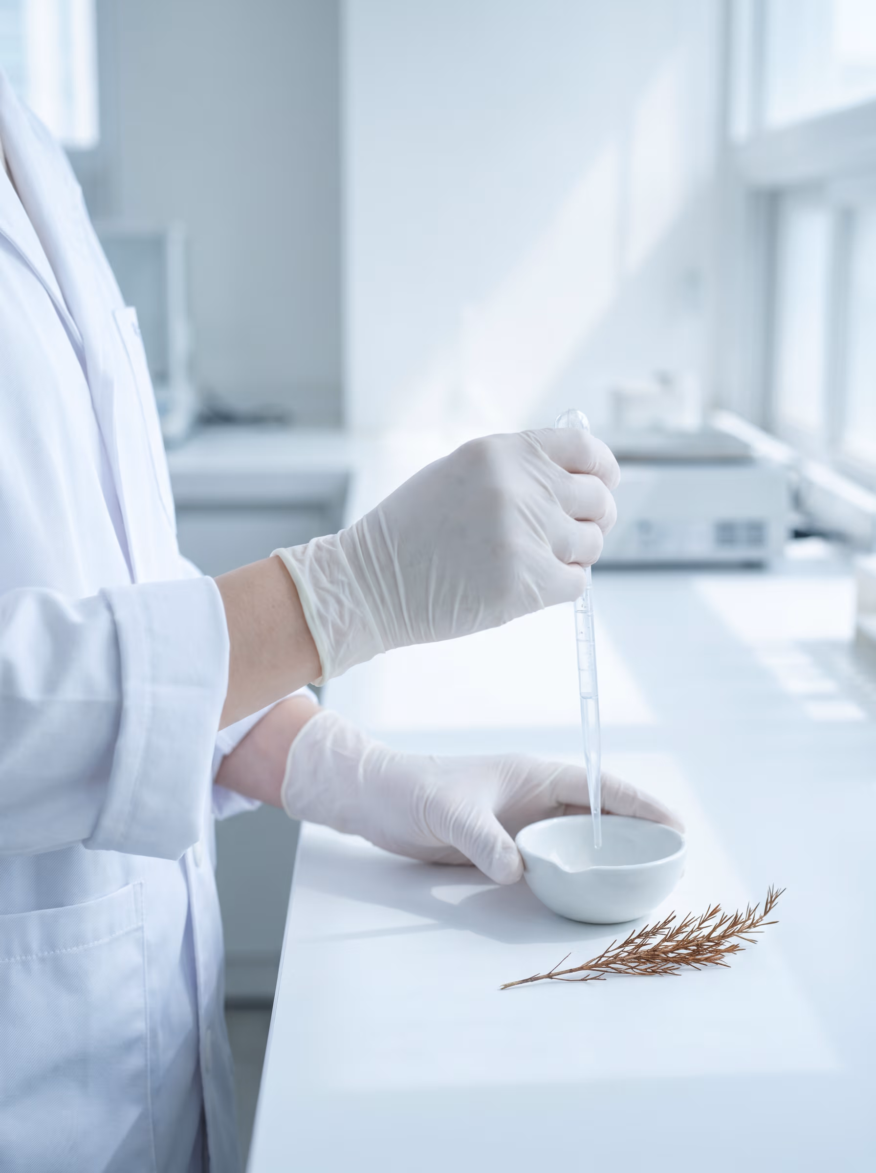 Hands working in a Korean cosmetic laboratory — precise, measured, evidence-led.